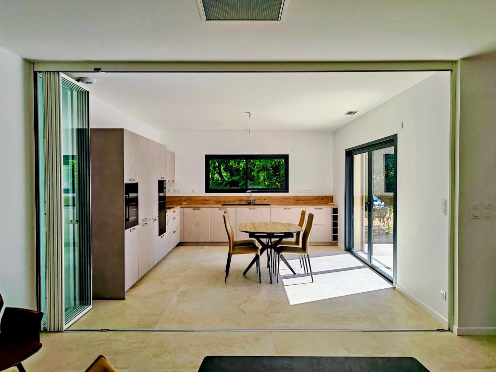 Installation d'un système coulissant-pivotant tout verre effet verrière dans une villa contemporaine basée dans le Rhône (69)